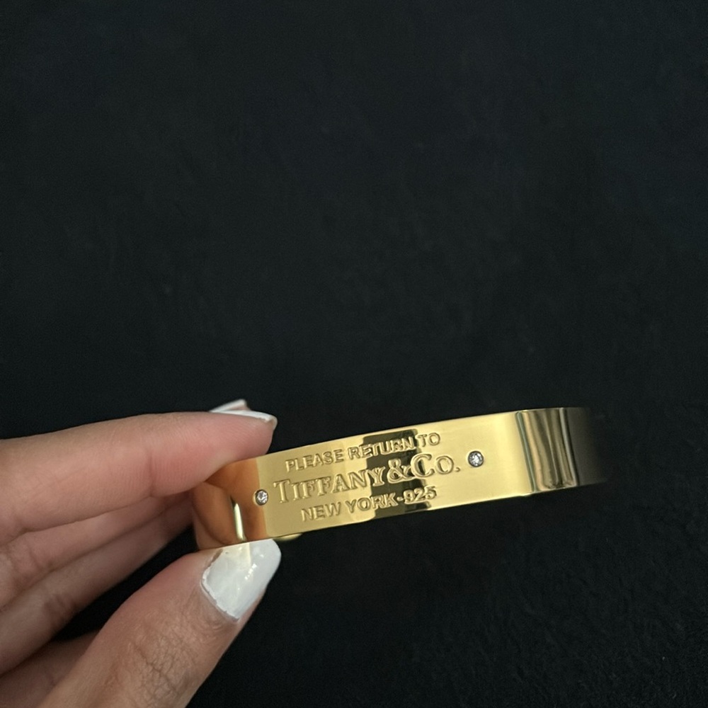 Gold finish cuff.